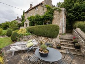 a patio with a table and chairs and a building at 3 Bed in Bath oc-skn21 in Wellow