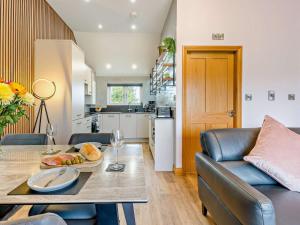 a kitchen and living room with a table and a couch at 2 Bed in Castle Douglas oc-59638 in Castle Douglas