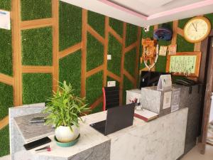 an office with a green wall with a clock at Sheoak Retreat Tajpur in Tajpur