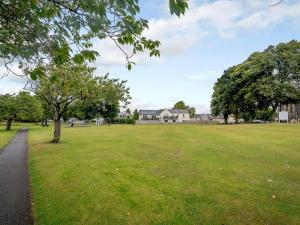 a park with a tree and a grass field at 2 Bed in Castle Douglas oc-59638 in Castle Douglas