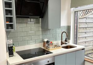 a kitchen with a sink and a counter top at Stylish 1-Bedroom Apartment in Chapel Allerton with Free Parking in Moortown +7 photos