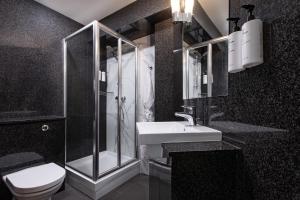 a bathroom with a shower and a toilet and a sink at STG Hotel Oxford Street - formerly St Giles London Hotel in London