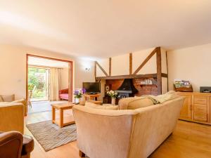 a living room with a couch and a fireplace at 3 Bed in Evesham oc-89477 in Bretforton +11 photos