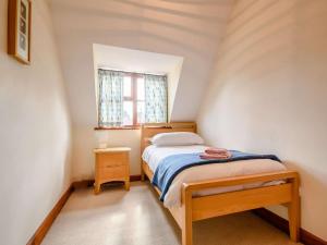 a small bedroom with a bed and a window at 3 Bed in Evesham oc-89477 in Bretforton