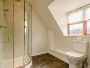 a bathroom with a toilet and a glass shower at 3 Bed in Evesham oc-89477 in Bretforton