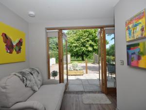 a living room with a couch and a sliding glass door at 1 Bed in Banbury oc-57103 in Upper Brailes
