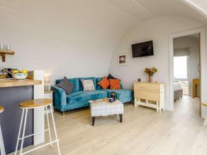 a living room with a blue couch and a table at 2 Bed in Tain oc-81340 in Nigg
