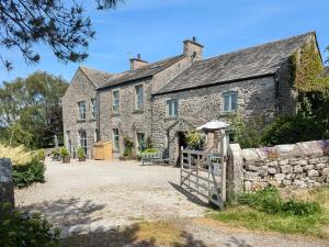 an old stone house with a gate in front of it at 1 Bed in Carnforth oc-90528 in Beetham