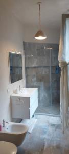 a bathroom with a sink and a glass shower at Millenovecento in Cremona