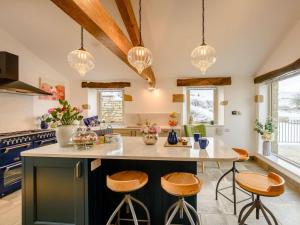 a kitchen with a large island with bar stools at 5 Bed in Lancaster oc-90546 in Burton in Lonsdale