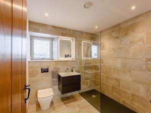 a bathroom with a toilet and a sink and a shower at 5 Bed in Lancaster oc-90546 in Burton in Lonsdale +28 photos