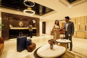 a man and a woman standing in a hotel lobby at Liza Royale Hotel Near Chennai central Railway Station in Chennai