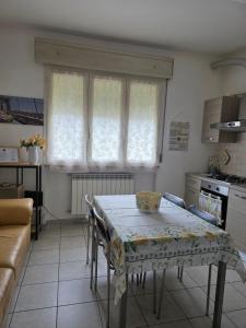 a kitchen with a table with a table cloth on it at Residence Mariele in Tavazzano