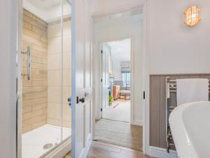 a bathroom with a tub and a shower and a sink at 4 Bed in Broughton-in-furness oc-sz183 in Ulpha +15 photos
