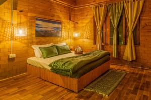 a bedroom with a large bed in a room at Riverside Mudhouse Duplex Cottage by Kahani in Jibhi +24 photos
