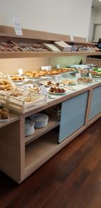 a buffet with many different types of bread and pastries at Best Western Hotel San Marco in Siena