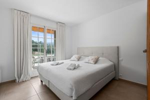 a white bedroom with a bed and a window at Villa Olivia - Golfe de Saint-Tropez in Cogolin +15 photos