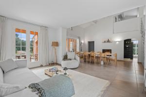 a living room with a couch and a table at Villa Olivia - Golfe de Saint-Tropez in Cogolin