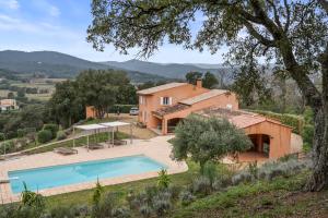 an external view of a house with a swimming pool at Villa Olivia - Golfe de Saint-Tropez in Cogolin