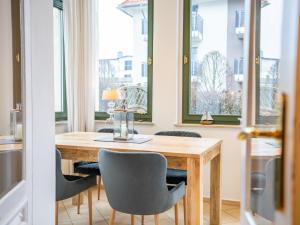 a dining room with a wooden table and chairs at Villa Goodewind 100 m zum Strand in Ahlbeck +10 photos