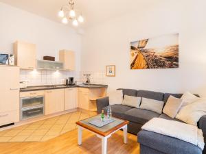 a living room with a couch and a table at Villa Goodewind 100 m zum Strand in Ahlbeck