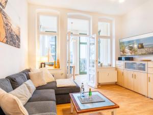 a living room with a couch and a tv at Villa Goodewind 100 m zum Strand in Ahlbeck