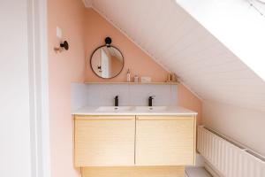 a bathroom with a sink and a mirror at Le Louis Vakantiehuis in Lanaken +24 photos
