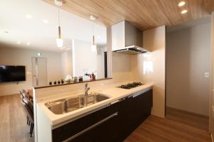 a kitchen with a sink and a counter at Unite in Myoko in Taguchi