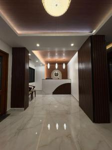 a lobby with a reception desk in a building at Hotel Royal Luxe - US consulate, Apollo hospital, Sankara natralya in Chennai