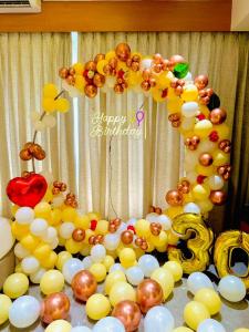 a bunch of balloons and a balloon arch with a number nine at Hotel Royal Retreat in Shirdi