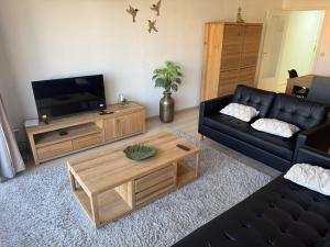 a living room with a couch and a coffee table at Casa Ghentele in Blankenberge