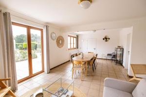 a living room with a table and chairs and a couch at Le Louis Vakantiehuis in Lanaken