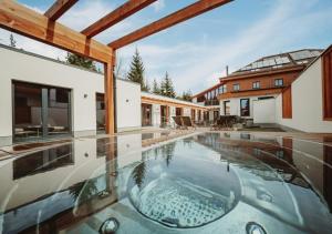 an image of a house with a swimming pool at Hotel Horal in Rožnov pod Radhoštěm