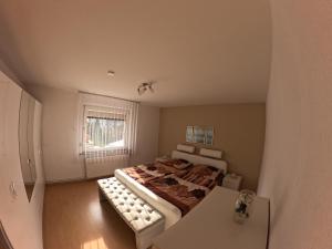 a bedroom with a large bed and a window at fewo-twete in Stadtoldendorf