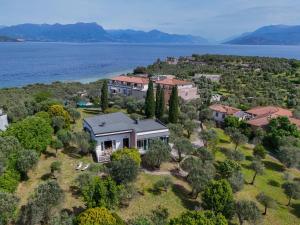 an aerial view of a house on an island in the water at MGH - Villa Sirmione in Sirmione