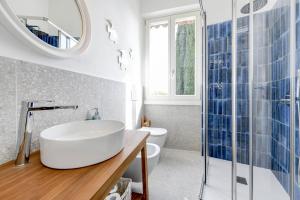 a bathroom with a sink and a toilet and a mirror at MGH - Villa Sirmione in Sirmione +42 photos
