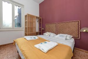 a bedroom with two beds with towels on them at MGH - Villa Sirmione in Sirmione