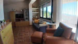 a living room with a couch and a table at CRYSTAL BAY in Paleo Tsifliki