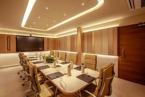 a conference room with a long table and chairs at Purple Elephant Luxury Business Hotel in Cochin +28 photos