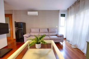a living room with a couch and a table at Rual Suites By Cuencaloft in Cuenca