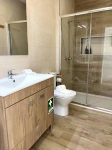 a bathroom with a sink and a toilet and a shower at Cor de Mar • Pátio • 2 Quartos • Centro Histórico in Peniche +40 photos