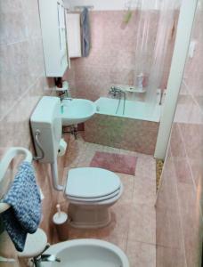 a bathroom with a toilet and a sink at Antica dimora LUNA in Casarano