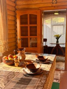 a table with plates and bowls of fruit on it at Садиба Людмила in Pilipets