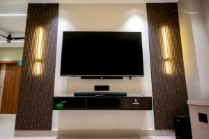 a flat screen tv on a wall in a room at Skyline signature in Rānchī