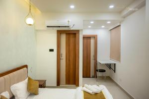 a hotel room with a bed and a hallway at Skyline signature in Rānchī