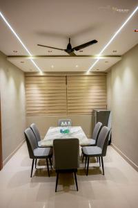 a dining room with a table and chairs at Skyline signature in Rānchī +1 photo