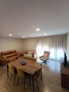 a living room with a table and a couch at Apartamentos Elvira Valderrobres in Valderrobres