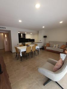 a living room with a couch and a table and chairs at Apartamentos Elvira Valderrobres in Valderrobres