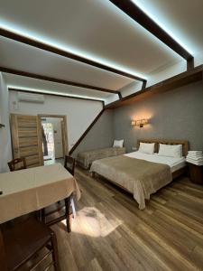 a large room with two beds and a table at База отдыха Дубки in Orlovshchina +101 photos