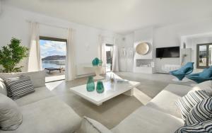 a living room with a couch and a table at Margi Villas in Mikonos